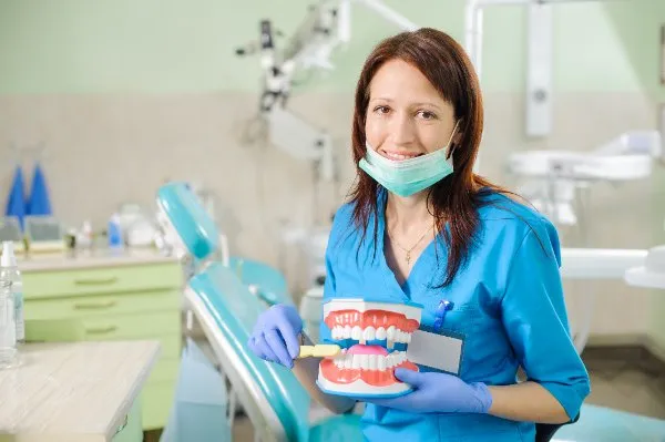 female-dentist-showing-dental-jaw-model-and-toothb-2025-01-16-22-52-20-utc1-68230f3f7d026